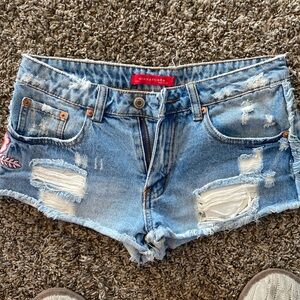 Jean cutoffs with pink flower appliqué